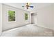 Bedroom featuring neutral carpet, closet, and natural light from two windows at 328 Pamela St, Gastonia, NC 28054
