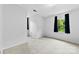 Bright bedroom with neutral carpet, white walls, and natural light from two windows with blue curtains at 328 Pamela St, Gastonia, NC 28054