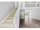 Bright entryway featuring hardwood floors, staircase with white railing, and open floor plan at 328 Pamela St, Gastonia, NC 28054