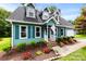 Charming two-story home featuring a well-maintained lawn, colorful flowerbeds, and inviting front porch at 328 Pamela St, Gastonia, NC 28054