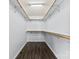 Walk-in closet with hardwood floors and custom shelving provides ample storage at 328 Pamela St, Gastonia, NC 28054
