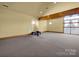 Spacious basement with high ceilings, neutral carpet, and large windows for natural light at 3351 Streamside Dr, Davidson, NC 28036