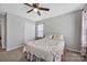 This is a cozy bedroom with soft carpet, neutral walls, a ceiling fan, and large closet at 3351 Streamside Dr, Davidson, NC 28036