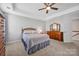 This bedroom features soft carpet, neutral walls, a ceiling fan and lots of storage space at 3351 Streamside Dr, Davidson, NC 28036
