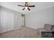 This bedroom features carpeted floors, neutral walls, a closet, and chair seating at 3351 Streamside Dr, Davidson, NC 28036