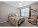 Comfortable bedroom with a queen-size bed, neutral decor, and ample natural light at 3351 Streamside Dr, Davidson, NC 28036