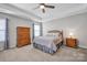 Charming bedroom with neutral walls, a ceiling fan, soft carpet and lots of natural light at 3351 Streamside Dr, Davidson, NC 28036