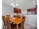 Dining area with wooden table set illuminated by a charming chandelier, perfect for Gathering meals at 3351 Streamside Dr, Davidson, NC 28036