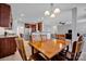 Cozy dining area with wooden table and chairs, flowing into the kitchen and living space at 3351 Streamside Dr, Davidson, NC 28036