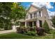Beautifully landscaped yard complements this home with stone accents and a welcoming front porch at 3351 Streamside Dr, Davidson, NC 28036
