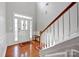 Bright foyer with hardwood floors, high ceilings, and elegant staircase creates a grand entrance at 3351 Streamside Dr, Davidson, NC 28036