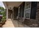 Inviting front porch with stone accents and a comfortable seating area; a perfect outdoor retreat at 3351 Streamside Dr, Davidson, NC 28036