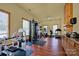 Well-equipped gym features modern exercise equipment and hardwood floors with natural light at 3351 Streamside Dr, Davidson, NC 28036