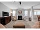 Inviting living room features a fireplace, comfortable seating, and large windows for natural light at 3351 Streamside Dr, Davidson, NC 28036
