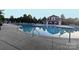 Community pool with steel rails, lounge seating, and a red clubhouse in background at 3351 Streamside Dr, Davidson, NC 28036