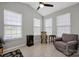 Bright sunroom with multiple windows, ceiling fan, and cozy seating area at 3351 Streamside Dr, Davidson, NC 28036