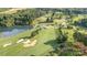 Picturesque aerial view of the golf course with lush greenery, sand traps, and a tranquil lake at 3441 Club Ridge Ct, Gastonia, NC 28056