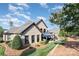 Rear exterior of the home highlighting the brick facade, manicured lawn, and relaxing outdoor seating at 3441 Club Ridge Ct, Gastonia, NC 28056
