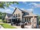 Beautiful brick home featuring an outdoor patio, fireplace, and landscaped backyard at 3441 Club Ridge Ct, Gastonia, NC 28056