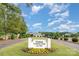Inviting entrance to Gaston Country Club featuring manicured landscaping and clear signage at 3441 Club Ridge Ct, Gastonia, NC 28056