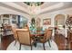 An elegant dining room featuring rich dark hardwood flooring and a round table with seating for six at 3441 Club Ridge Ct, Gastonia, NC 28056