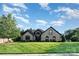 Well-maintained home exterior with a lush green lawn and manicured landscaping enhancing curb appeal at 3441 Club Ridge Ct, Gastonia, NC 28056