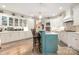 A large, open kitchen features an island with seating, white cabinetry, and a modern design aesthetic at 3441 Club Ridge Ct, Gastonia, NC 28056