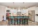 Bright kitchen boasts white cabinets, a center island with seating, stainless steel appliances, and decorative accents at 3441 Club Ridge Ct, Gastonia, NC 28056