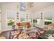 Cozy living room showcasing large windows, wicker furniture and stylish floral decor at 3441 Club Ridge Ct, Gastonia, NC 28056