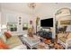 Comfortable living room with wicker seating, a floral rug, and decorative elements, adjacent to the dining area at 3441 Club Ridge Ct, Gastonia, NC 28056