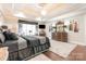 A serene main bedroom with hardwood floors, a tray ceiling, a sitting area, and a large dresser at 3441 Club Ridge Ct, Gastonia, NC 28056
