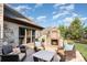Outdoor patio area with a stone fireplace, comfortable seating, and landscaped surroundings at 3441 Club Ridge Ct, Gastonia, NC 28056