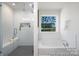 Luxurious bathroom showcasing a glass enclosed shower, a soaking tub, and neutral finishes at 36140 Greg Norman Dr # 1003, Lancaster, SC 29720