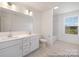 Bathroom featuring double sink vanity, tile floor, and natural light from a window at 36140 Greg Norman Dr # 1003, Lancaster, SC 29720