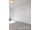 Bright bedroom with plush carpeting, doors, and white trim throughout at 36140 Greg Norman Dr # 1003, Lancaster, SC 29720