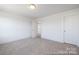 Neutral bedroom with plush carpeting and two doorways at 36140 Greg Norman Dr # 1003, Lancaster, SC 29720