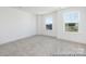 Bedroom with neutral carpet, base molding, and natural light from two windows at 36140 Greg Norman Dr # 1003, Lancaster, SC 29720