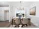 Dining room with neutral tones, modern light fixture, and large window offering ample natural light at 36140 Greg Norman Dr # 1003, Lancaster, SC 29720