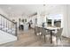 An open-concept design showcases the dining room adjacent to the kitchen and stairs at 36140 Greg Norman Dr # 1003, Lancaster, SC 29720
