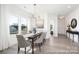 Bright dining room featuring a modern chandelier, large windows, and stylish decor at 36140 Greg Norman Dr # 1003, Lancaster, SC 29720