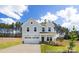 Charming two-story home featuring a two-car garage, a well-manicured lawn, and a welcoming front porch at 36140 Greg Norman Dr # 1003, Lancaster, SC 29720