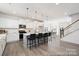 Spacious kitchen featuring a large island with bar stool seating, seamlessly flowing into the dining area at 36140 Greg Norman Dr # 1003, Lancaster, SC 29720