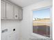 Laundry room with gray cabinets, natural light, and washer/dryer hookups at 36140 Greg Norman Dr # 1003, Lancaster, SC 29720