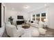 Inviting living room featuring a plush white sofa, a round coffee table, and large windows for natural light at 36140 Greg Norman Dr # 1003, Lancaster, SC 29720