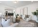 Bright living room with open floor plan, modern decor, and hardwood floors at 36140 Greg Norman Dr # 1003, Lancaster, SC 29720