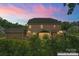 Large backyard with trees, a screened in porch, and attached garage at 4008 Pinot Way, Fort Mill, SC 29707