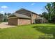 A spacious backyard with a well-maintained lawn and brick home, ideal for outdoor activities at 4008 Pinot Way, Fort Mill, SC 29707