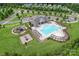 A pool and recreation area surrounded by lush greenery with playground equipment and parking nearby at 4008 Pinot Way, Fort Mill, SC 29707