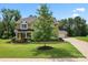 Beautiful two-story home with well-manicured lawn, mature trees, and a charming front porch at 4008 Pinot Way, Fort Mill, SC 29707
