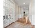 Inviting hallway with hardwood floors, wainscoting, and French doors leading to the office at 4008 Pinot Way, Fort Mill, SC 29707